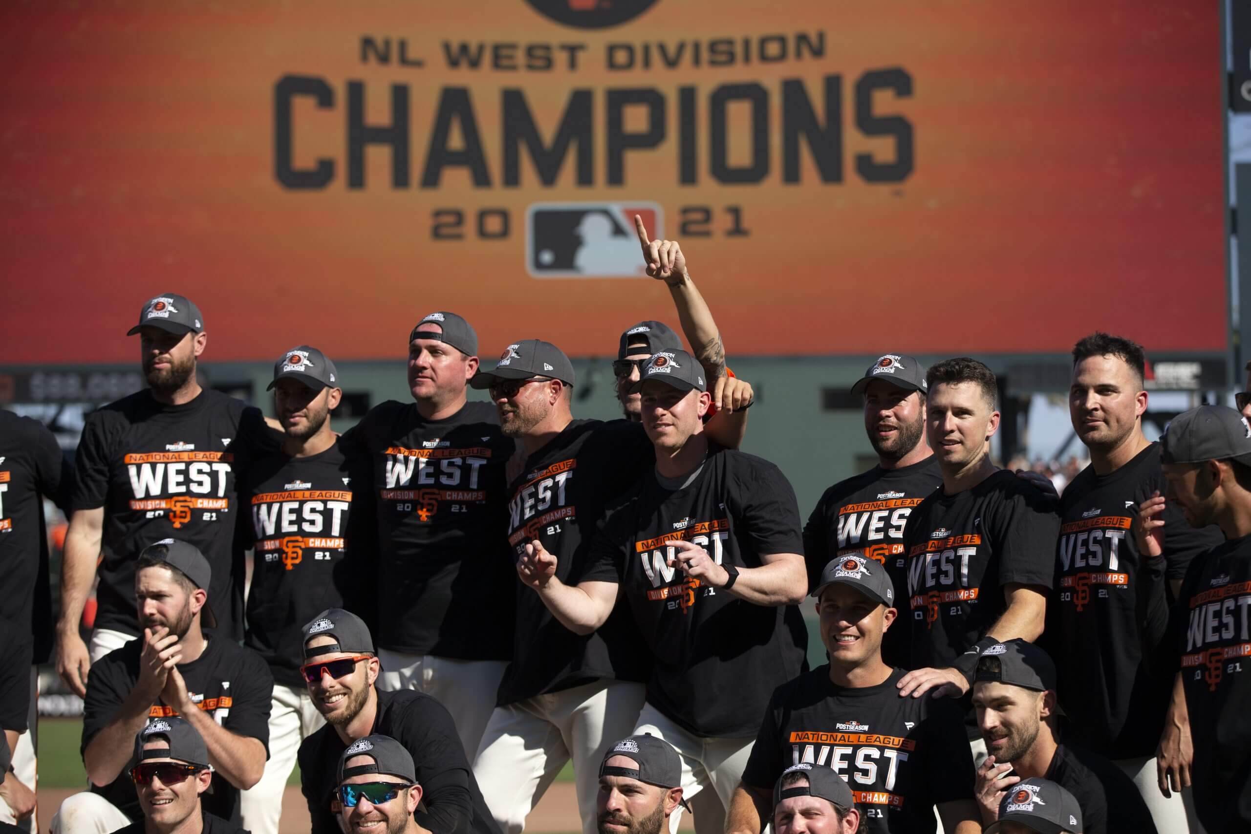 San Francisco Giants players and coaches pose for a group photo as they celebrate their 11-4 victory over the San Diego Padres at Oracle Park. The Giants clinched the National League West Division with the win.