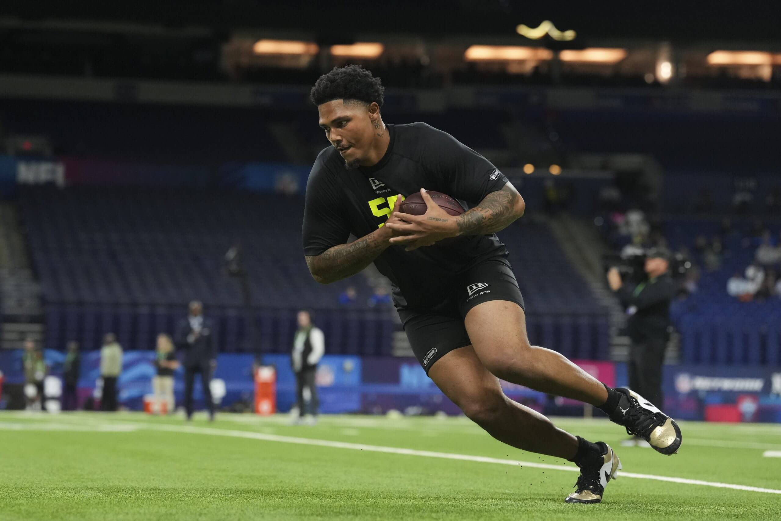 Clemson defensive lineman TJ Parker runs with the football hugged to his chest during the NFL Scouting Combine.