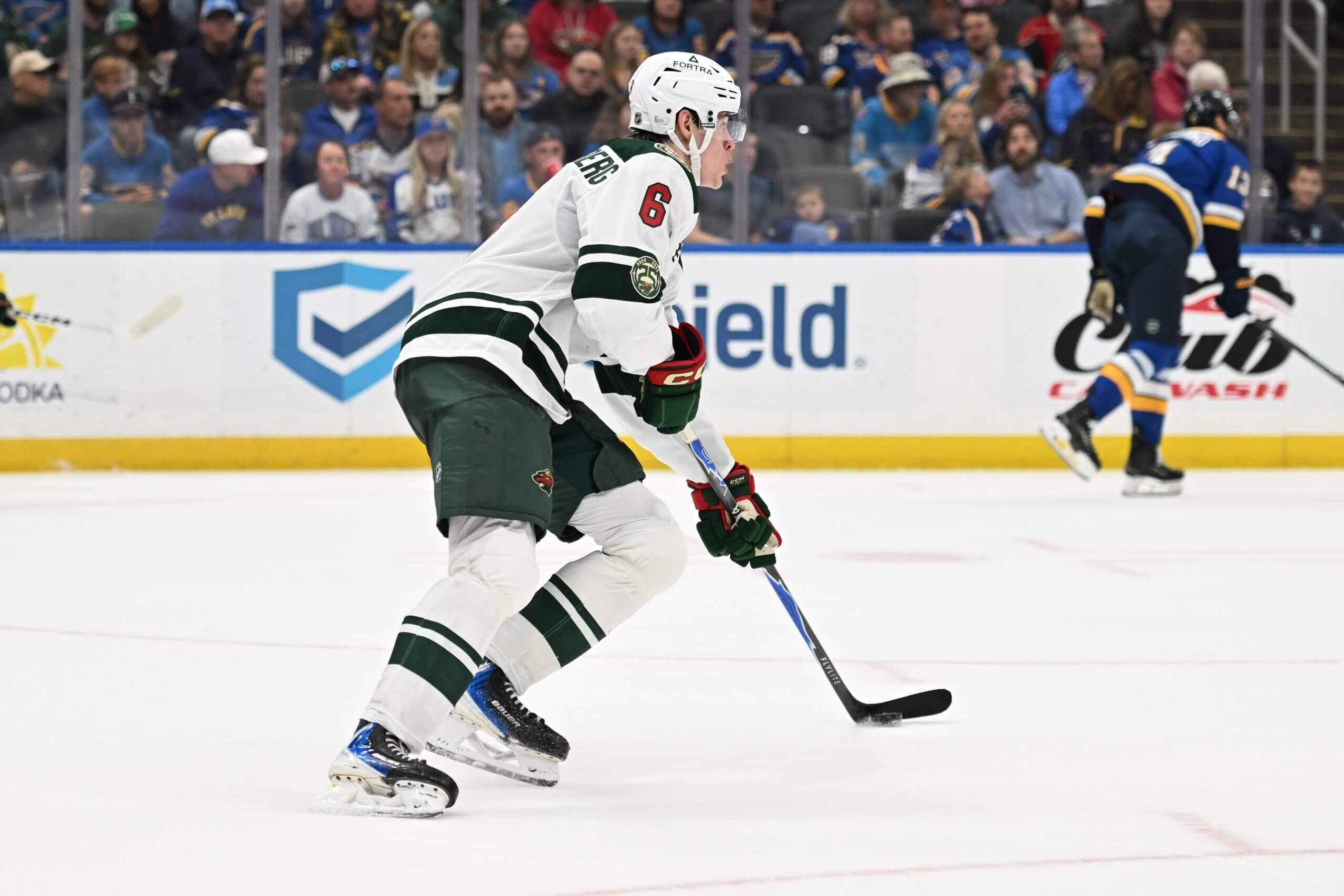 Viking Gustafsson Nyberg skates with the puck with a Blues player in the far distance.