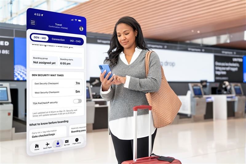 woman checking cell phone in airport lobby