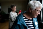 Penny Naumoff, left, observes the duck that has been nesting on her porch for weeks at the RoseVilla retirement community in Portland, Ore. on April 27, 2026.