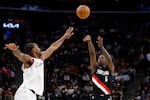 Portland Trail Blazers guard Jrue Holiday (5) shoots the ball while being guarded by LA Clippers forward Kawhi Leonard (2) during the first half of an NBA basketball game Tuesday, March 31, 2026, in Inglewood, Calif.