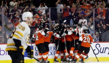 The Flyers celebrate Porter Martone's first career goal, which gave Philadelphia a 2-1 overtime win over the Bruins on Sunday.