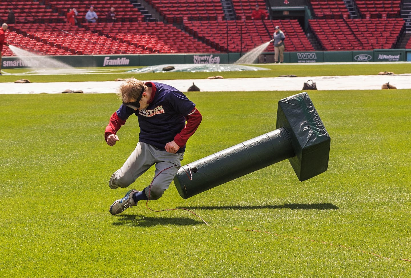 In an image taken by Tina Zhu Xi Caruso, Chris Kimball of the Boston Renegades is airborne as he tumbles into a sound-emitting base at Fenway Park.