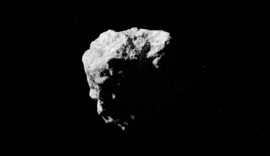 A rocky asteroid is pictured against the black of space.