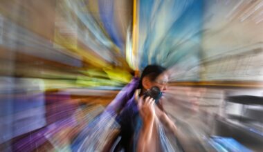 Tina Zhu Xi Caruso, 27, a functionally blind photographer, downloads images from her camera in Quincy. "Half the time I see faces, but I don't see expressions on faces," says Caruso, a disability advocate. "So I see you, but half the time I just see blobs of color for faces."