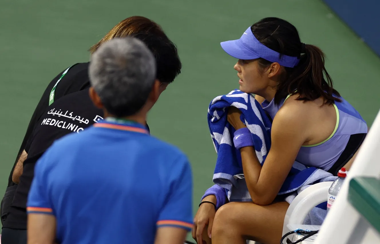 Tennis player Emma Raducanu receiving medical attention during a match.