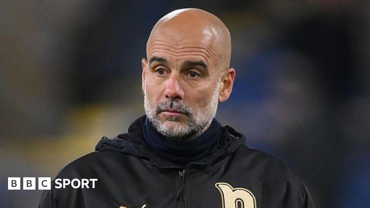 Guardiola in a black jacket with gold details watching on from the sidelines.