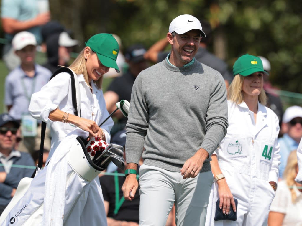 Northern Ireland’s Rory McIlroy reacts with his wife Erica Stoll on the third hole during the Par 3 Contest. REUTERS