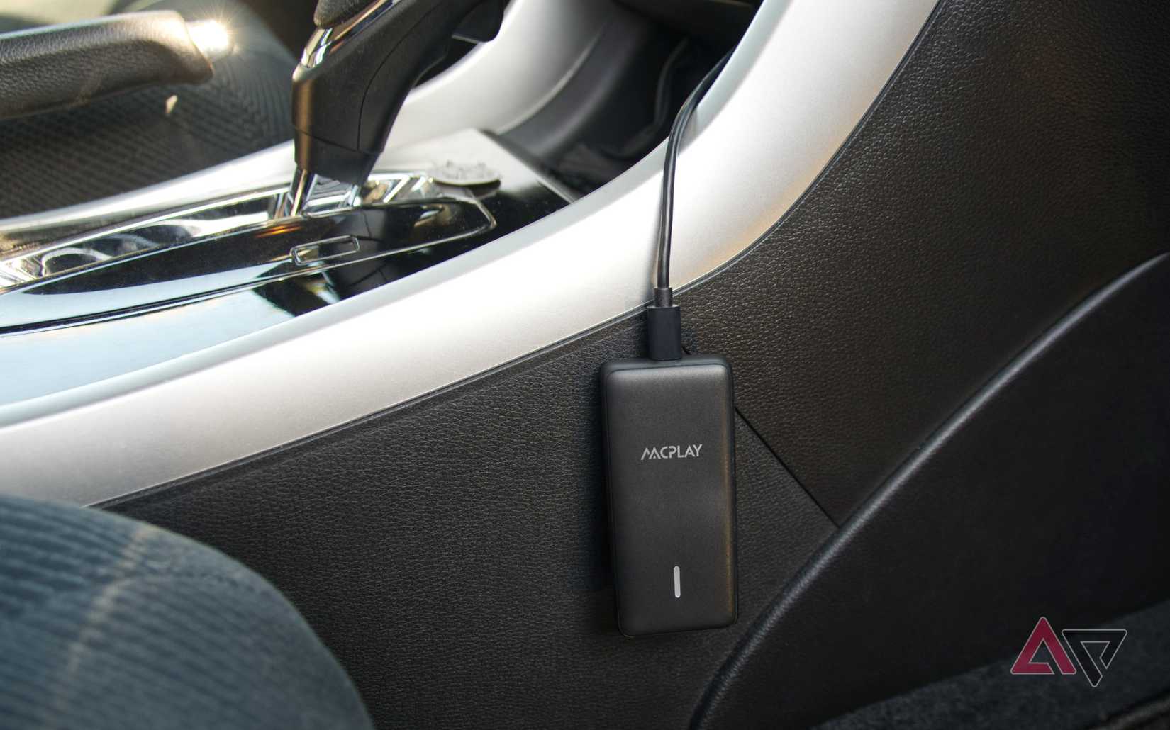 AACPlay Wireless Adapter hanging by its cable with the LED in view