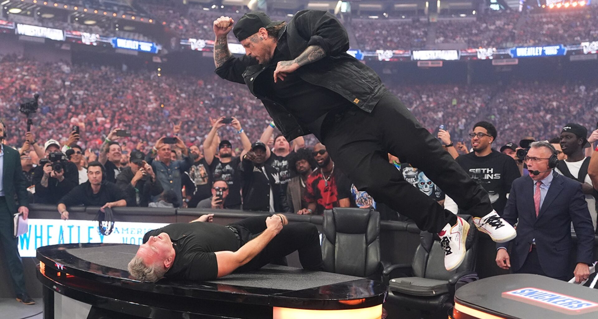 Jelly Roll Smashes Pat McAfee Through a Table at WrestleMania