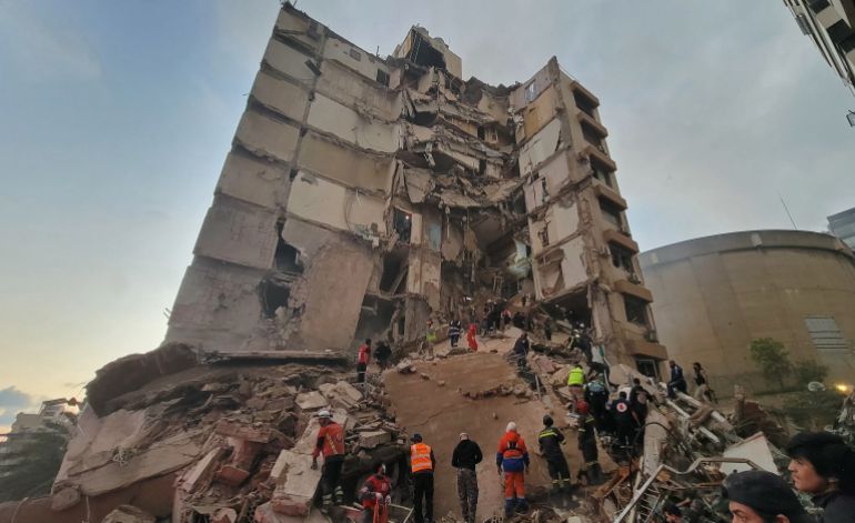 First responders and residents gather at the site of an Israeli airstrike in Beirut's Tallet al-Khayyat neighbourhood, on April 8, 2026.