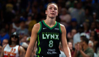 Alanna Smith wearing a Minnesota Lynx jersey walking on the court during a 2025 game against the Atlanta Dream.