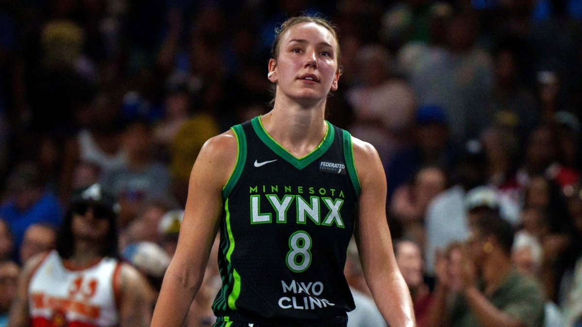 Alanna Smith wearing a Minnesota Lynx jersey walking on the court during a 2025 game against the Atlanta Dream.