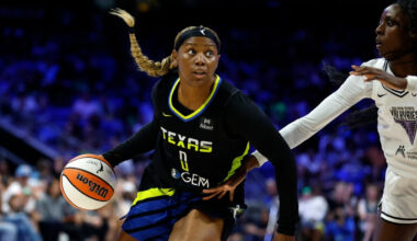 Amy Okonkwo #0 of the Dallas Wings drives against Laeticia Amihere #3 of the Golden State Valkyries at College Park Center.