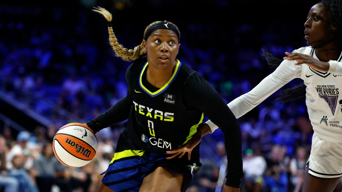 Amy Okonkwo #0 of the Dallas Wings drives against Laeticia Amihere #3 of the Golden State Valkyries at College Park Center.