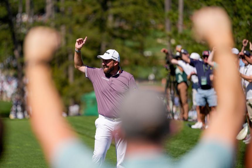 Shane Lowry, of Ireland, waves after a hole-in-one on the sixth hole during the third round of the Masters golf tournament on Saturday.