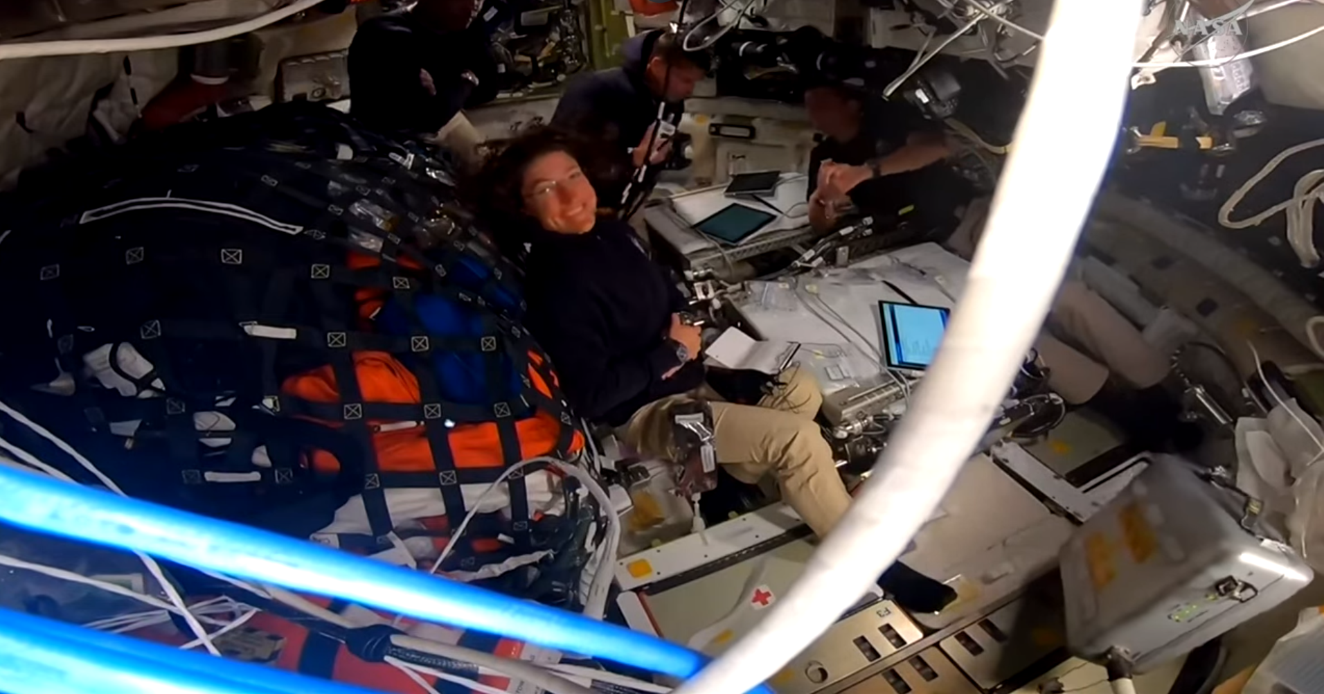 The Artemis II crew floats in Orion; NASA astronaut Christina Koch smiles at the camera as NASA a