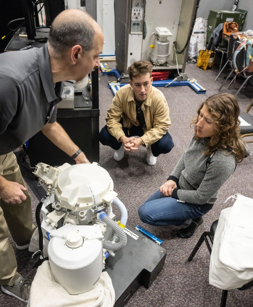 Christina Koch participates in the activation of the Orion spacecraft’s toilet system.