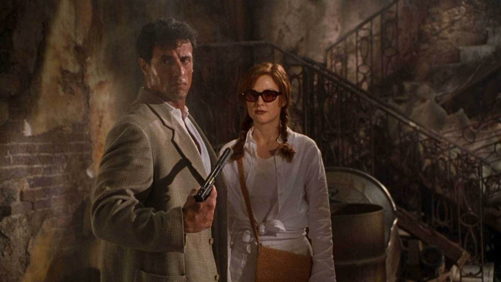 Robert Rath (Sylvester Stallone) and Electra (Julianne Moore) exploring a derelict building in Assassins