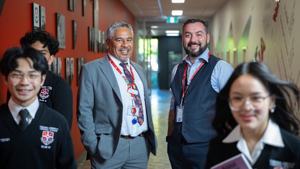 Caroline Chisholm Catholic College principal Napoleon Rodezno with deputy principal Tristan O’Brien and students.