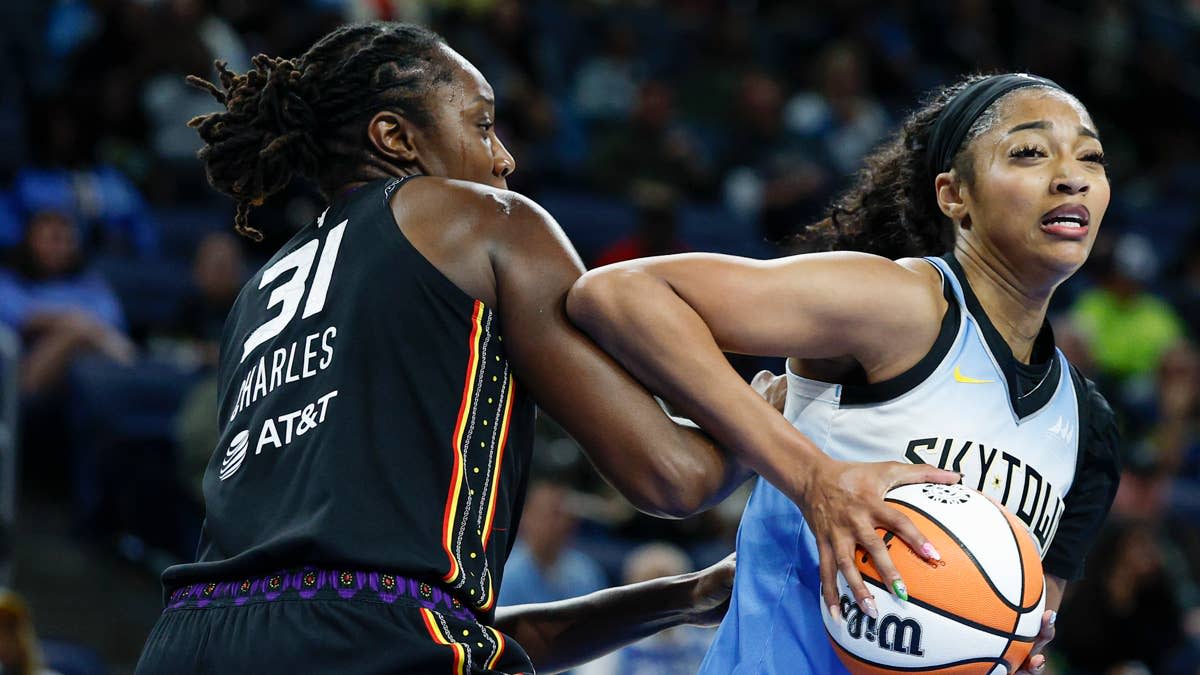 Chicago Sky forward Angel Reese (5) drives to the basket against Connecticut Sun center Tina Charles (31).Kamil Krzaczynski-Imagn Images