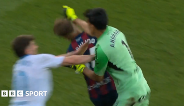 Real Zaragoza goalkeeper Esteban Andrada punches Huesca captain Jorge Pulido