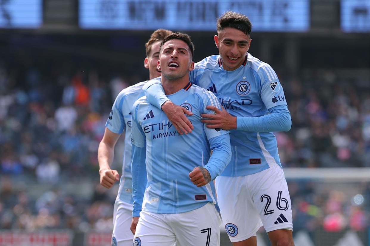 New York City FC player Nicolás Fernández celebrates his goal, with two teammates joining in his excitement.