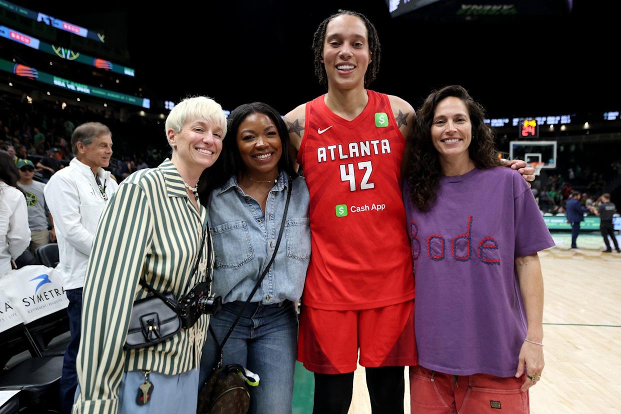Megan Rapinoe, Brittney Griner, Cherelle Griner, and Sue Bird posing together at Climate Pledge Arena