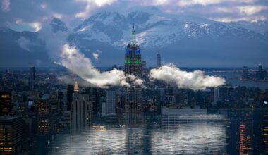 two photographs digitally superimposed, like a double-exposure, depicting the Manhattan skyline with clouds and snow-capped mountains in the background