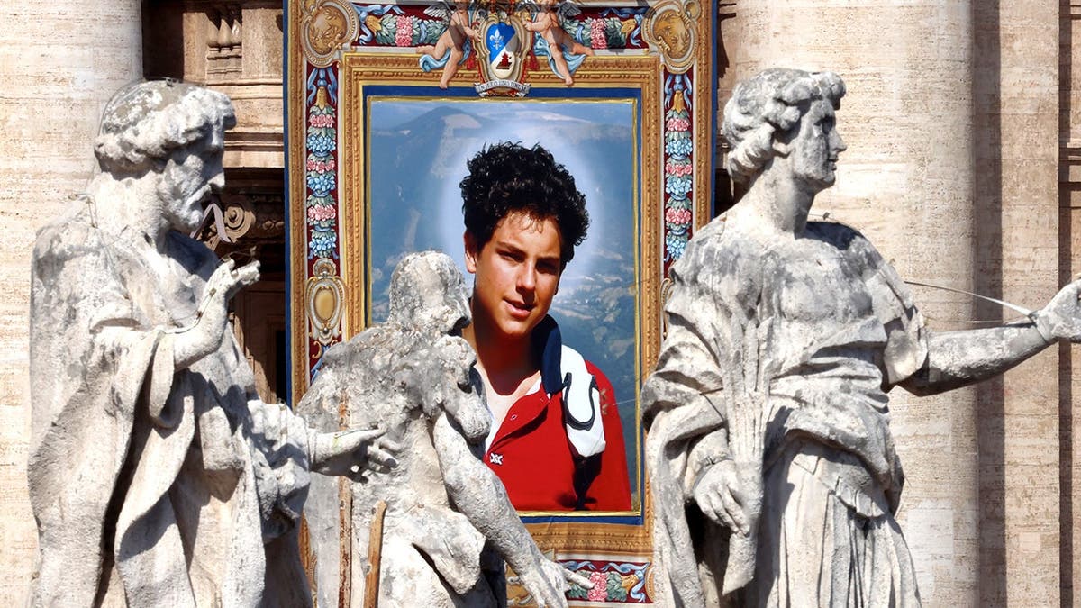 Tapestry of Carlo Acutis displayed on St. Peter’s Basilica during canonization ceremony.