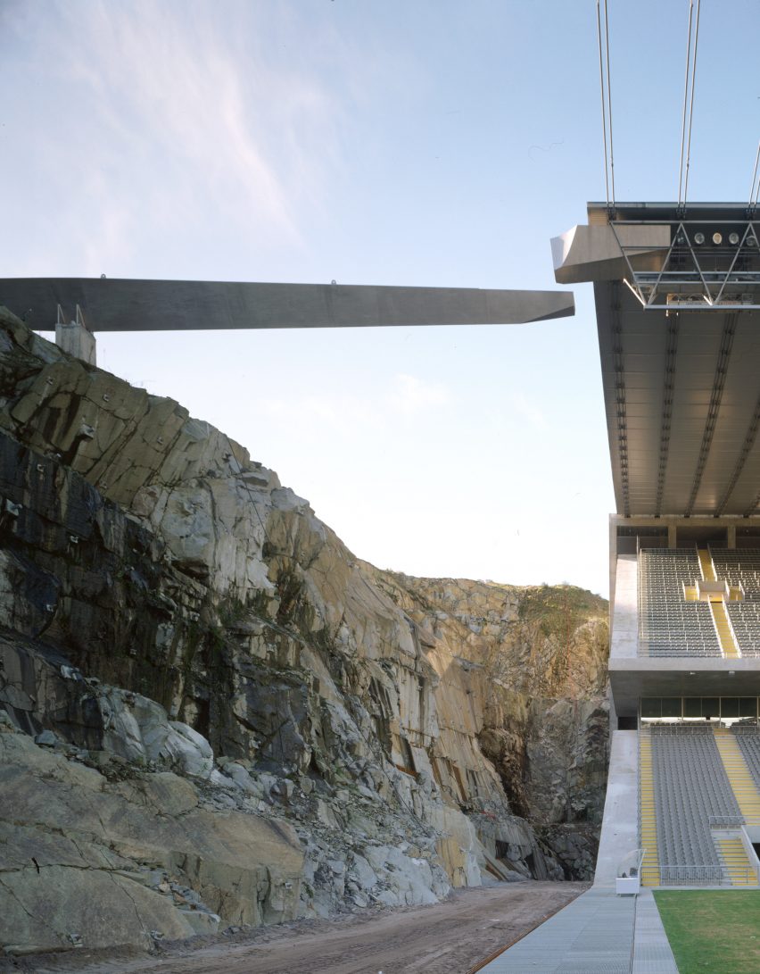 Interior view of the stadium showing the rock face beside one side of the seating tiers