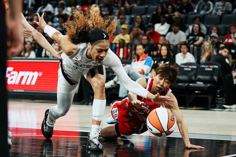 Las Vegas Aces guard Chennedy Carter (23) and Japan Suzuno Higuchi (74) reach for the ball during first half of WNBA preseason game on Sunday April 26, 2026 at Michelob Ultra Arena in Las Vegas.