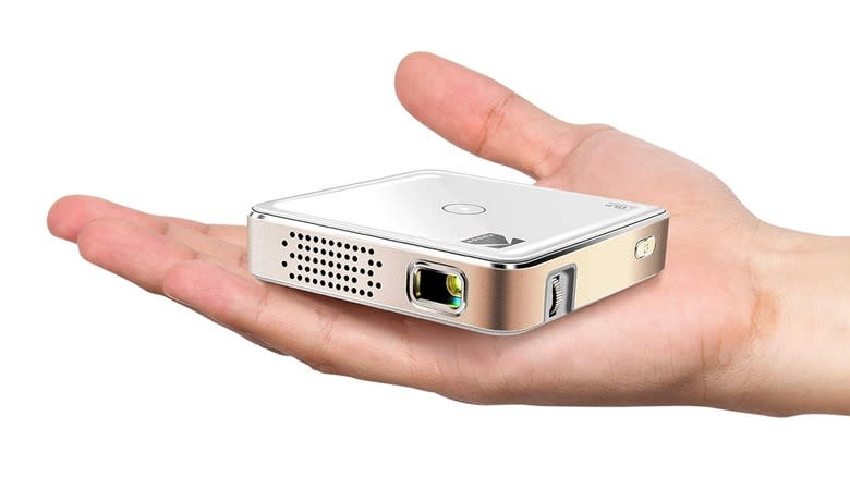 The Kodak Luma 75 projector on a person's hand.
