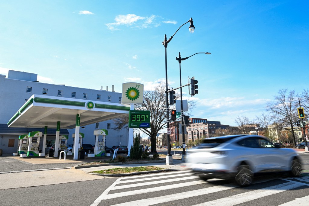 A car passes a BP gas station in Washington, D.C., where regular gasoline costs $3.99 per gallon.