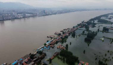 Floodwater surrounds homes in China as rising river levels and coastal flood risks threaten low-lying communities.