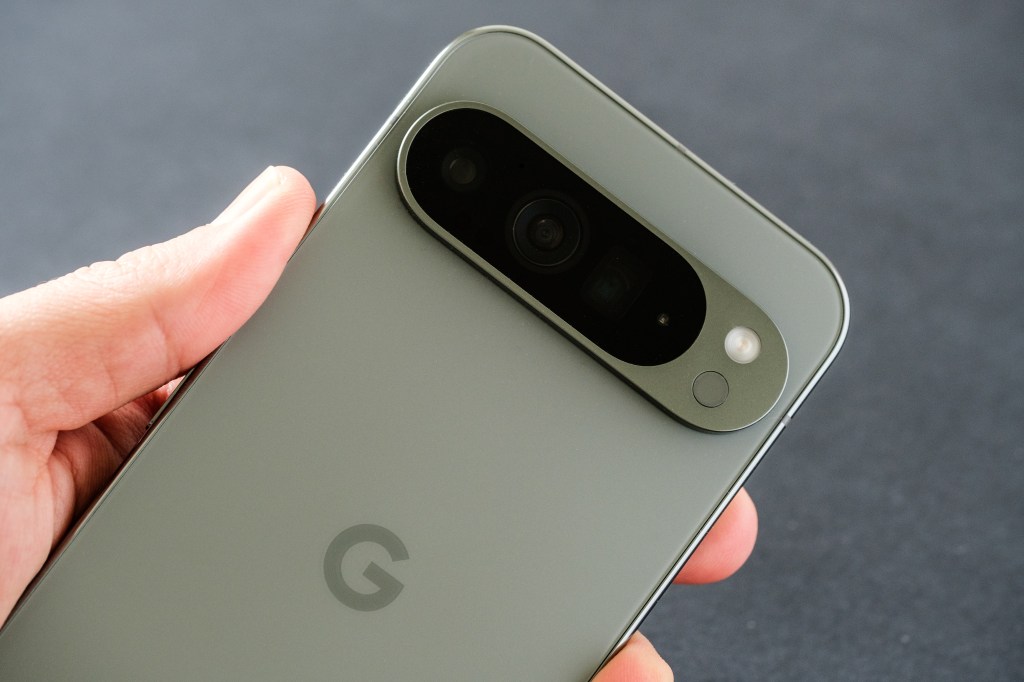 Close-up of the Google Pixel 9 Pro XL in Hazel Green, focusing on its triple camera, held in hand.