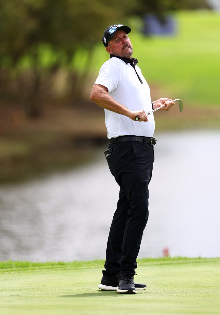 Phil Mickelson reacting during the second round of a golf tournament.