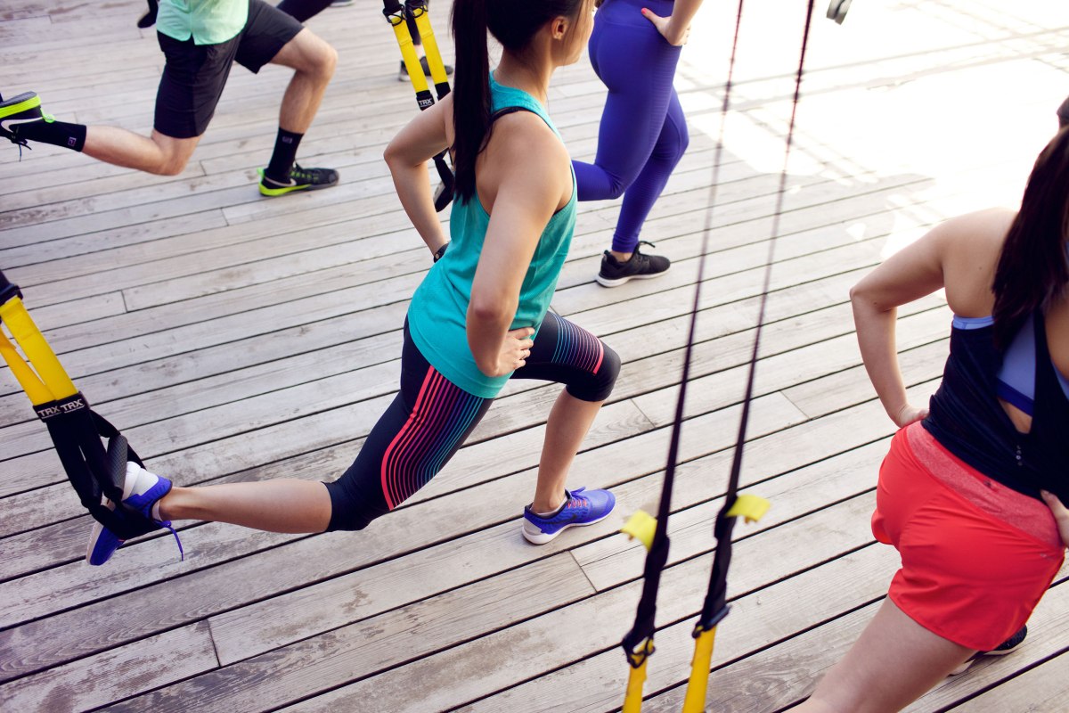 people in workout clothes stretching