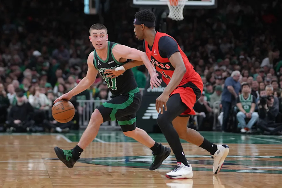 Apr 5, 2026; Boston, Massachusetts, USA; Boston Celtics guard Payton Pritchard (11) dribbles the ball against Toronto Raptors guard Ja'Kobe Walter (14) during the first half at TD Garden. Mandatory Credit: Gregory Fisher-Imagn Images