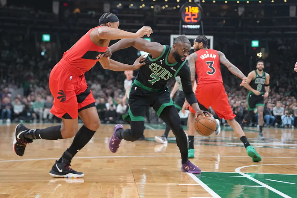 Apr 5, 2026; Boston, Massachusetts, USA; Boston Celtics guard Jaylen Brown (7) dribbles the ball past Toronto Raptors forward Scottie Barnes (4) during the first half at TD Garden. Mandatory Credit: Gregory Fisher-Imagn Images