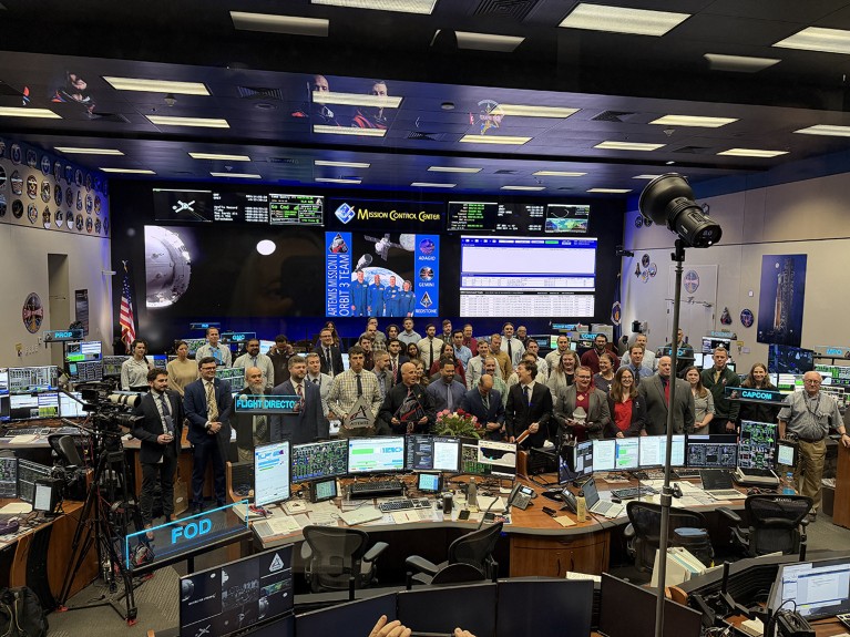 Houston Mission Control staff in a group photo during the Artemis II project, as the Orion capsule with astronauts approach the moon.