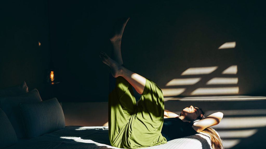 A person exercising while lying on their back.