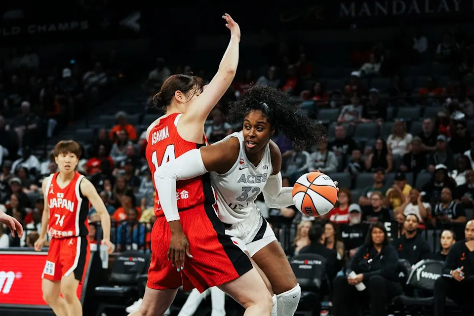 Las Vegas Aces forward Cheyenne Parker-Tyus (32) takes the ball around Japan center Azusa Ashahina (14) during first half of WNBA preseason game on Sunday April 26, 2026 at Michelob Ultra Arena in Las Vegas.