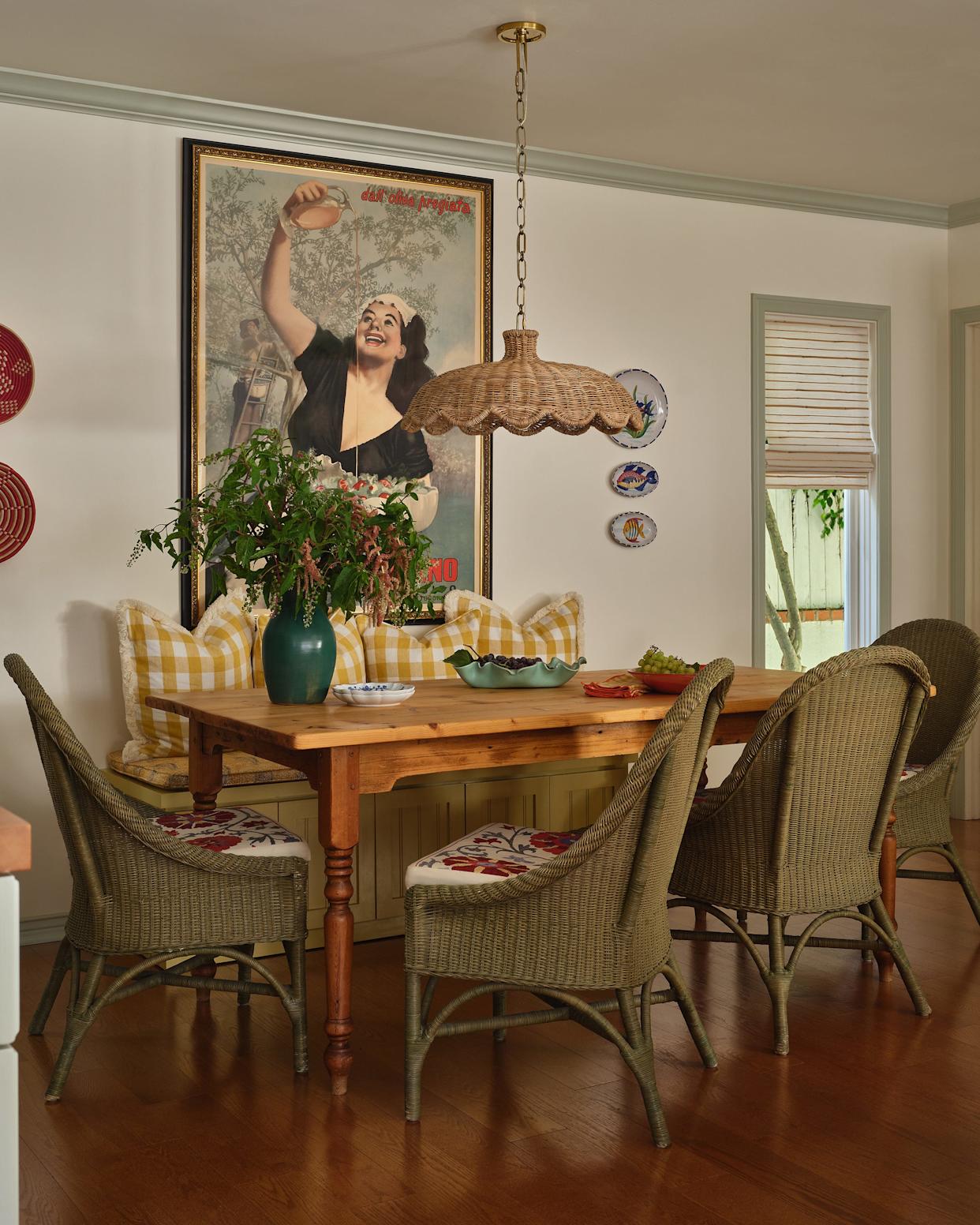 Dining area with wooden table and wicker chairs.