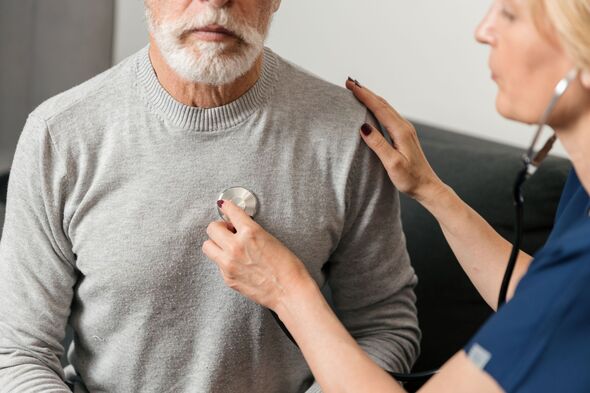 Doctor checks heartbeat of elderly patient during home visit consultation Doctor checks heartbeat of elderly patient during home visit consultation