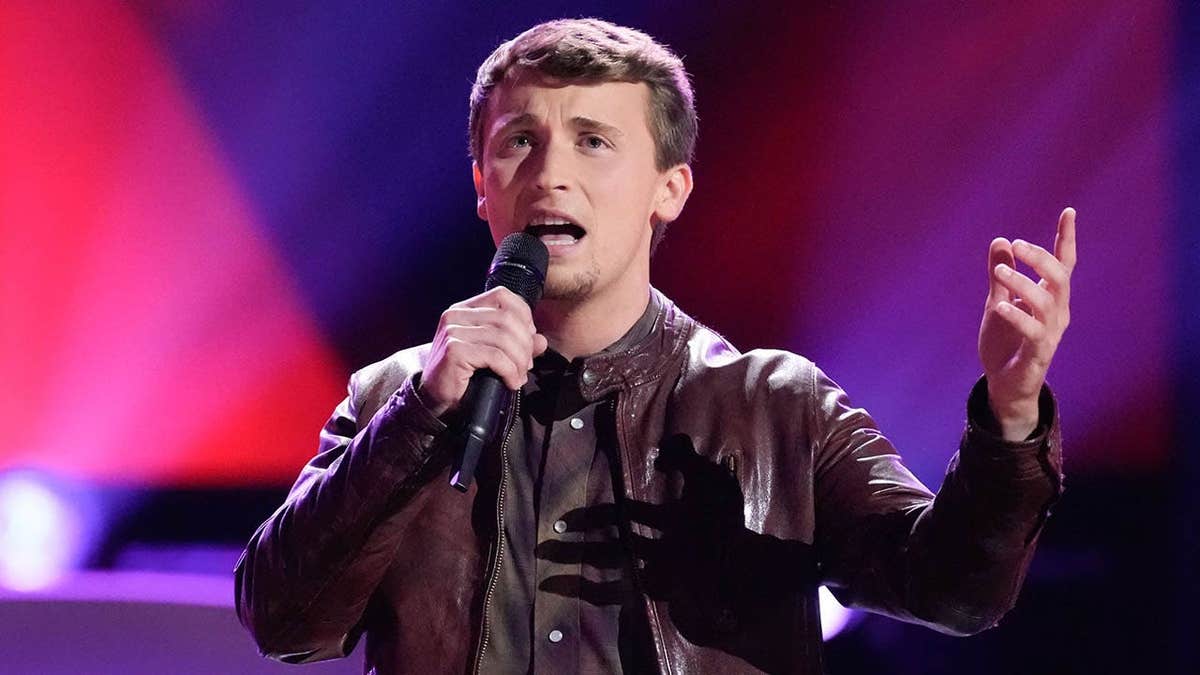 Dylan Carter singing on The Voice stage during blind auditions