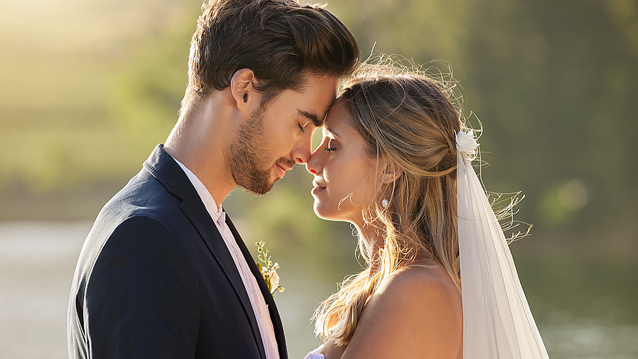 Newly married groom and bride embracing each other