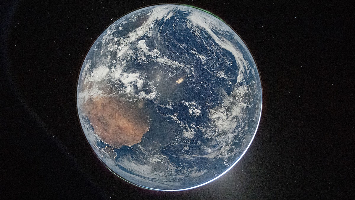 NASA astronaut and Artemis II Commander Reid Wiseman views Earth from Orion spacecraft window