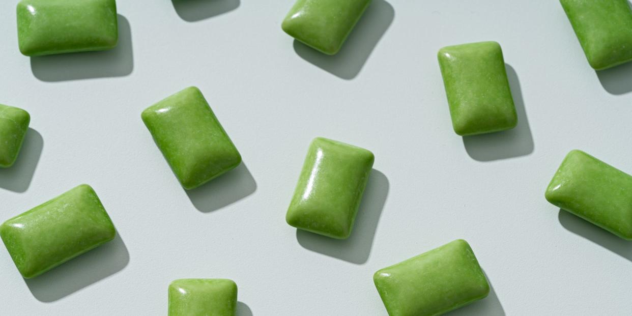 green chewing gums scattered on green background directly above view